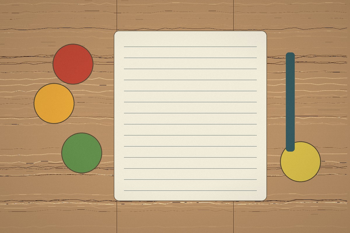 Seasonal fruit beside an open notebook and pencil on a wooden table.