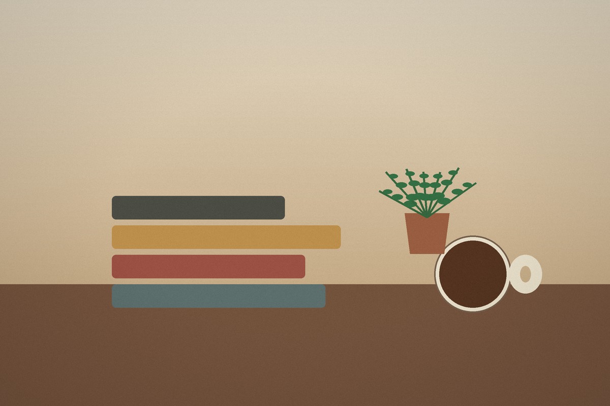 Stack of books, plant and coffee cup in a warm interior